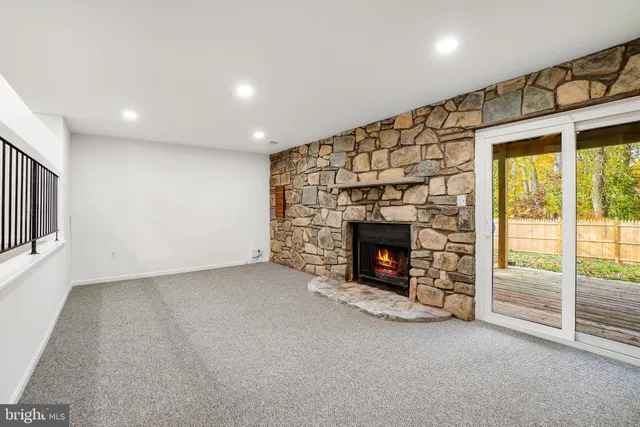 an empty room with a fireplace and window