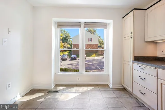 a view of kitchen with window and refrigerator