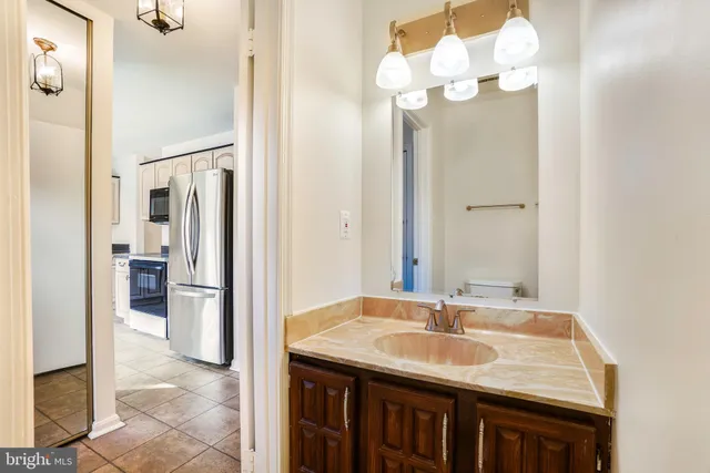 a bathroom with a sink vanity and a mirror