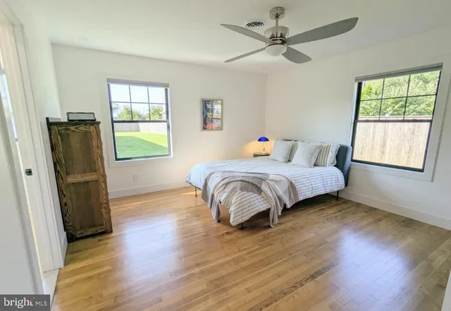 a bedroom with a bed a table and a window