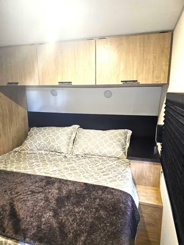 a bed sitting in a bedroom next to a window