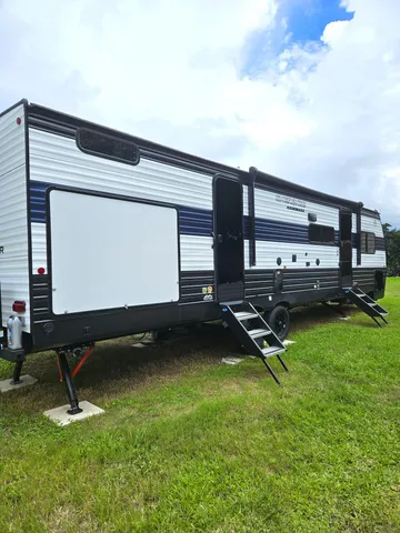 a view of a backyard with a chair and a ceiling fan