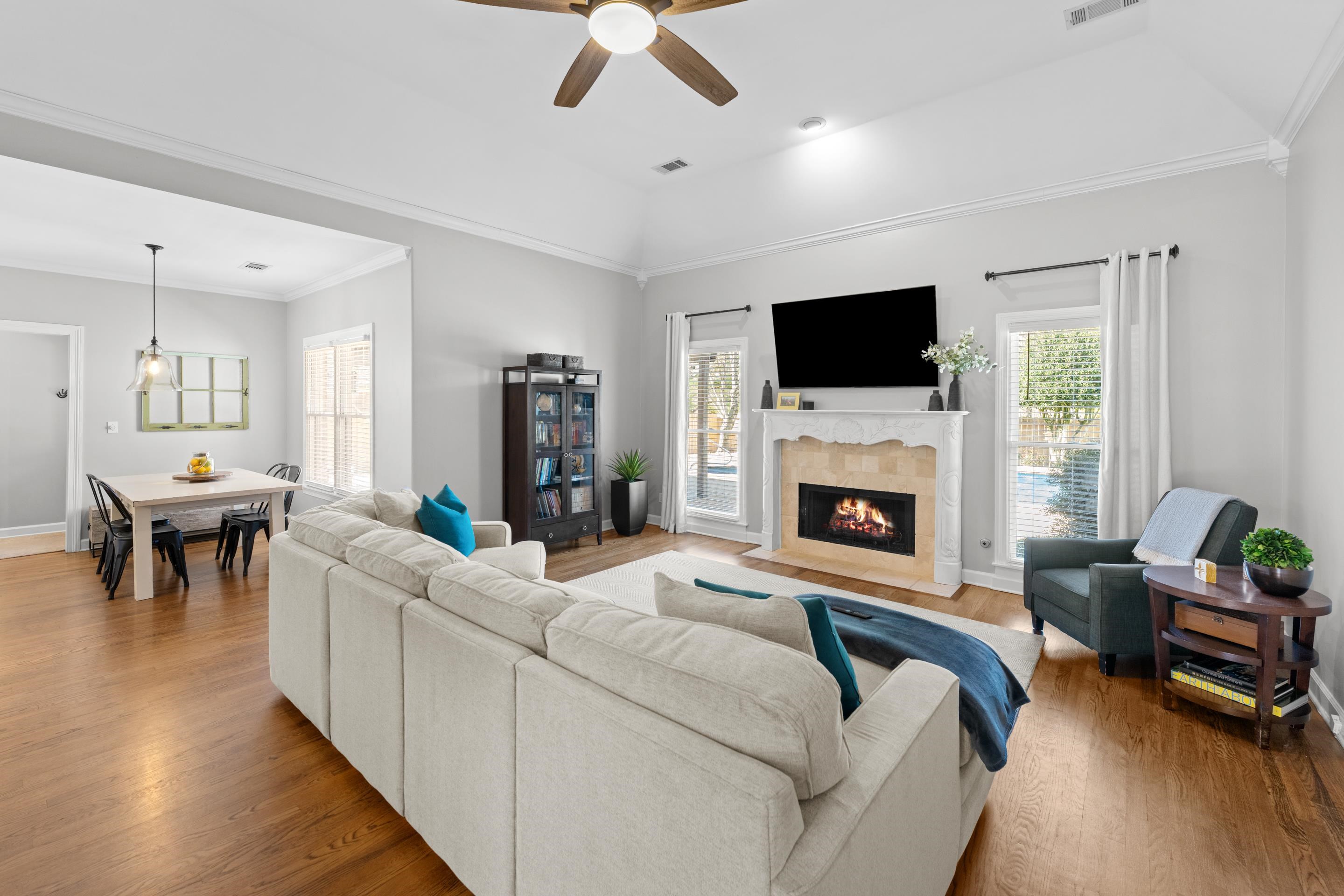 1339 Winoka Road Collierville, TN 38017 - Photo 13 of 40 a living room with furniture a flat screen tv and a fireplace