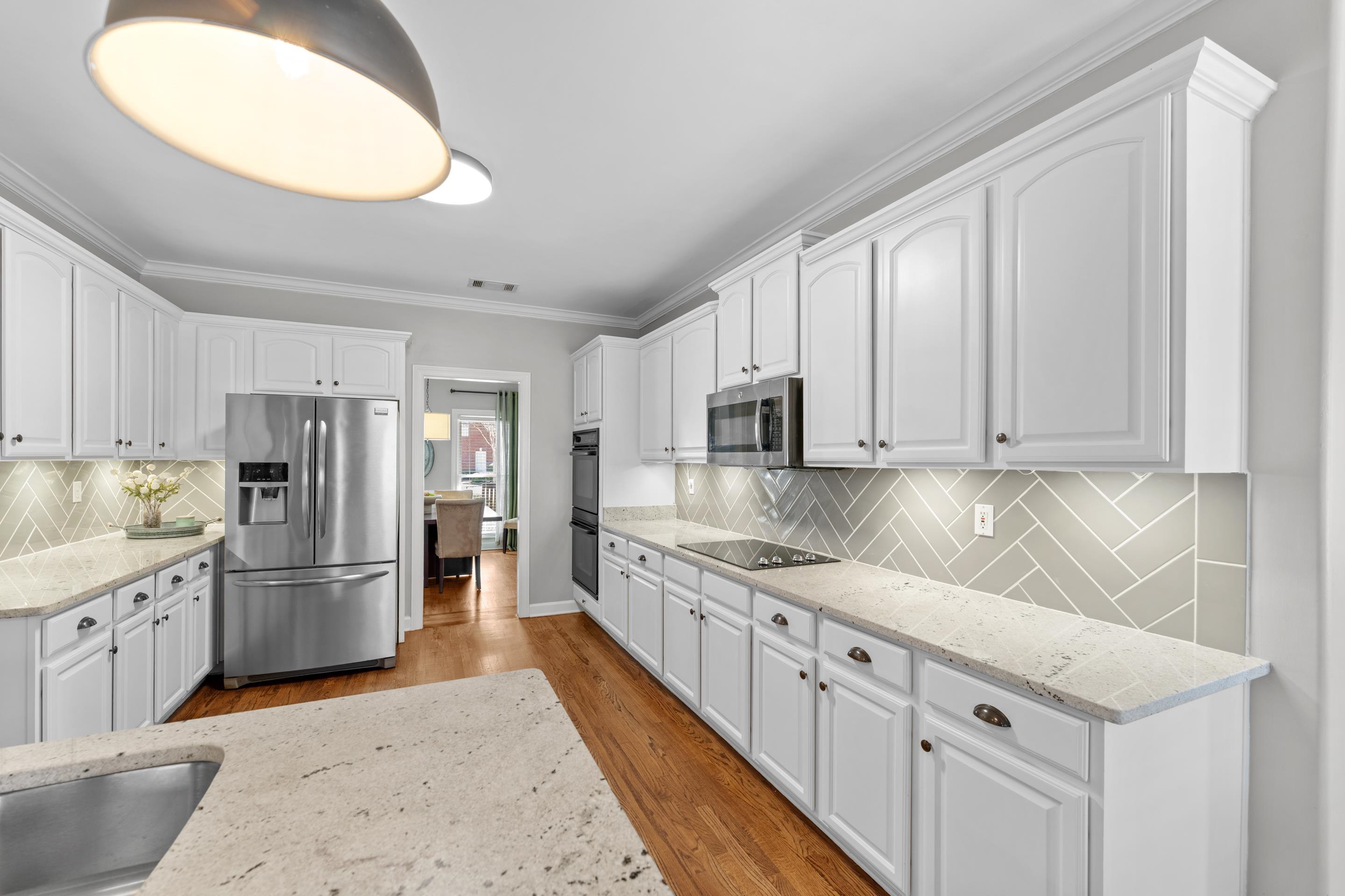 1339 Winoka Road Collierville, TN 38017 - Photo 14 of 40 a kitchen with stainless steel appliances granite countertop a refrigerator sink and cabinets