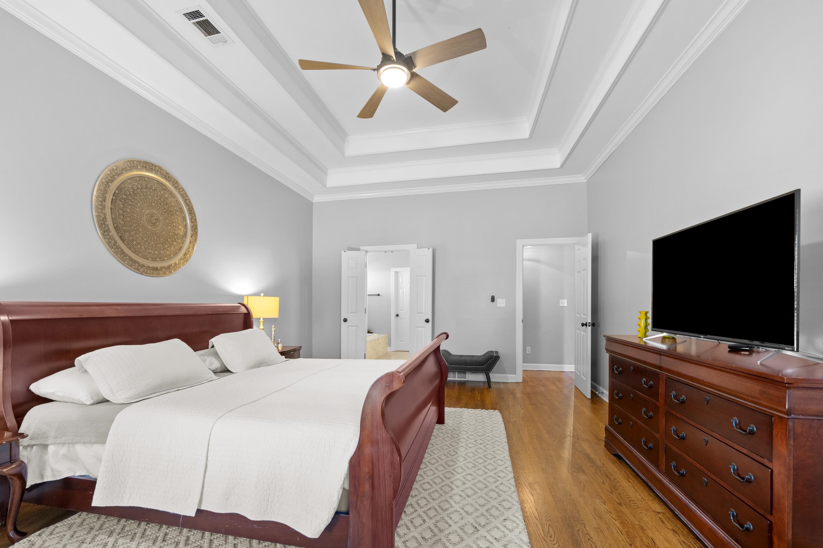 1339 Winoka Road Collierville, TN 38017 - Photo 17 of 40 a bedroom with a bed and a flat screen tv