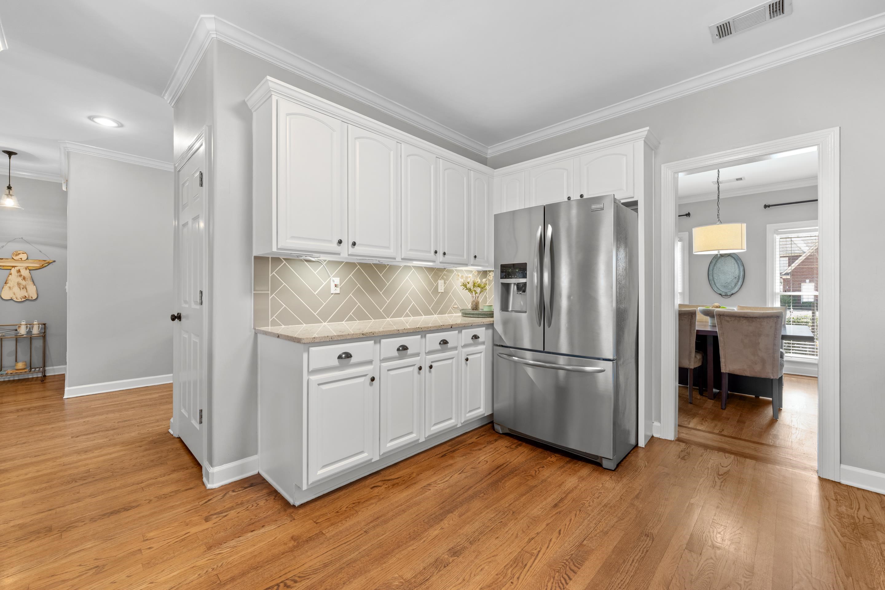 1339 Winoka Road Collierville, TN 38017 - Photo 2 of 40 a kitchen with wooden floors and appliances