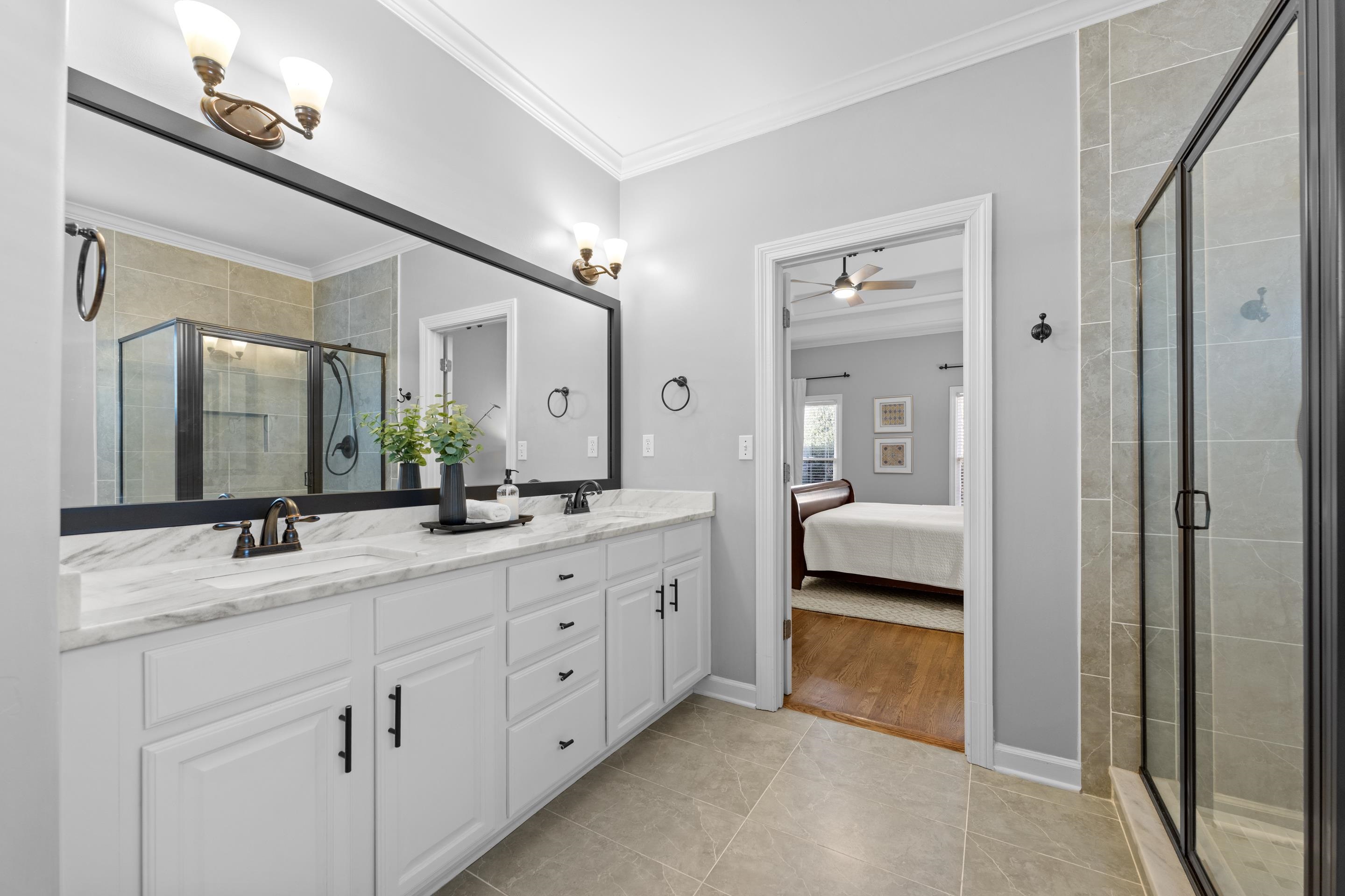 1339 Winoka Road Collierville, TN 38017 - Photo 25 of 40 a en suite bathroom with a double vanity sink and mirror