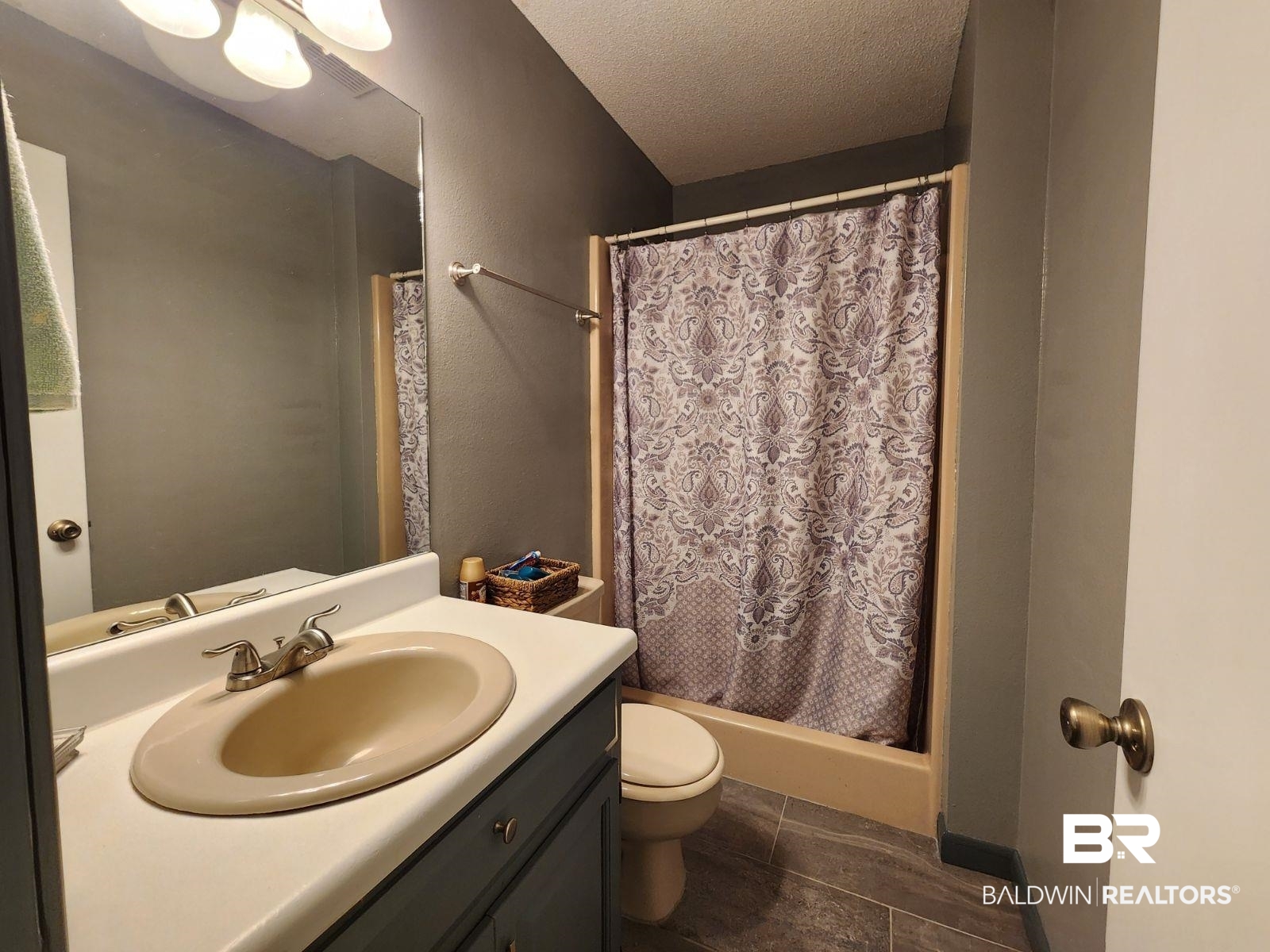 640 Horseshoe Road Brewton, AL 36426 - Photo 14 of 22 Bathroom featuring tile patterned floors, toilet, vanity, and a textured ceiling