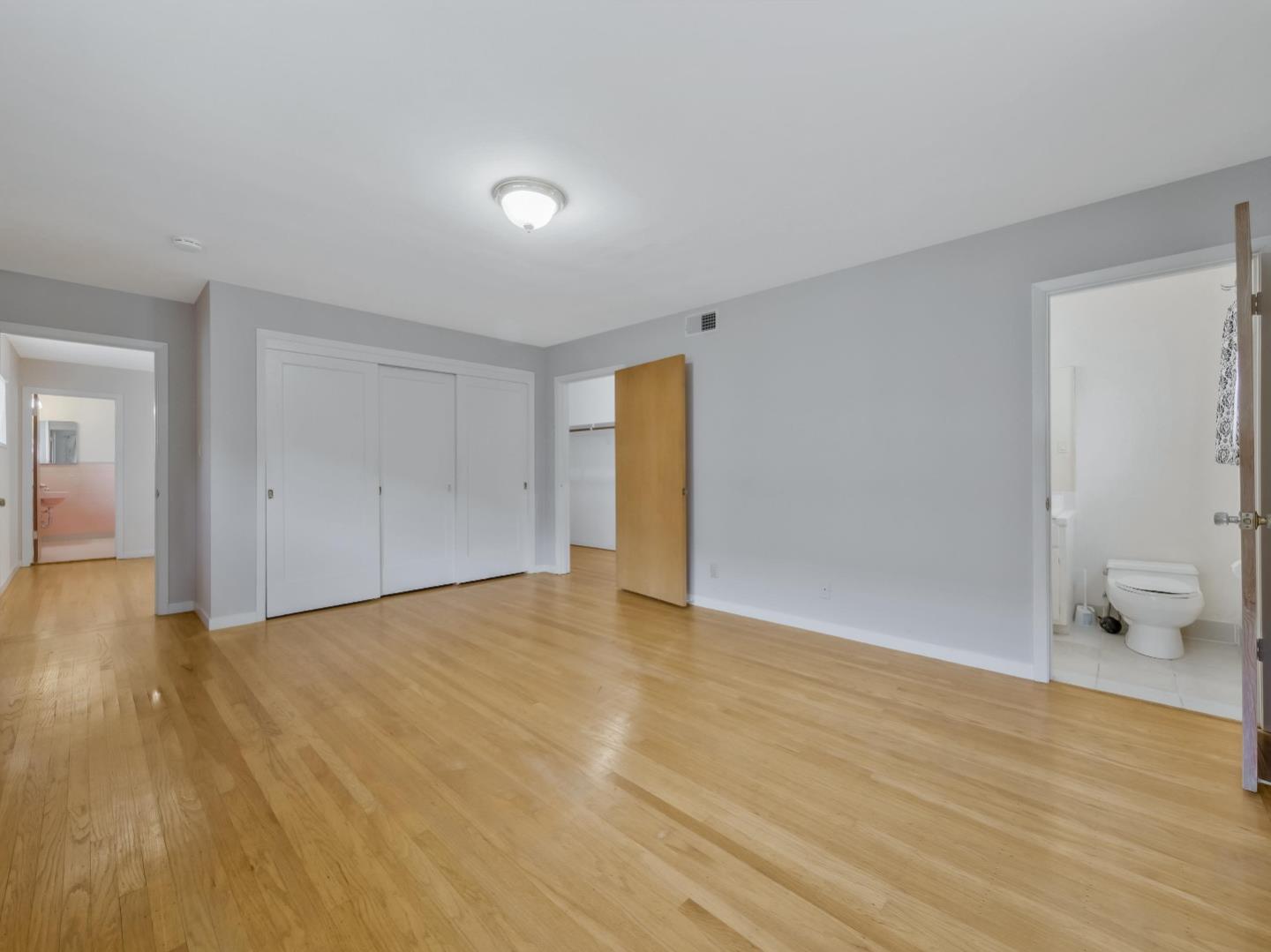 21 El Cerrito Avenue San Mateo, CA 94402 - Photo 4 of 13 a view of an empty room with wooden floor and a window