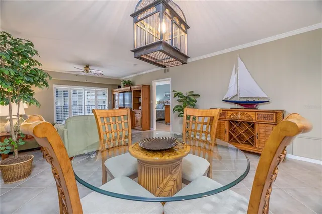 a kitchen with stainless steel appliances granite countertop a dining table chairs and granite counter tops