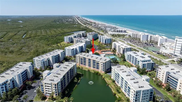 an aerial view of a house with a yard and a fountain