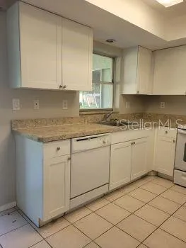 a kitchen with a sink and cabinets