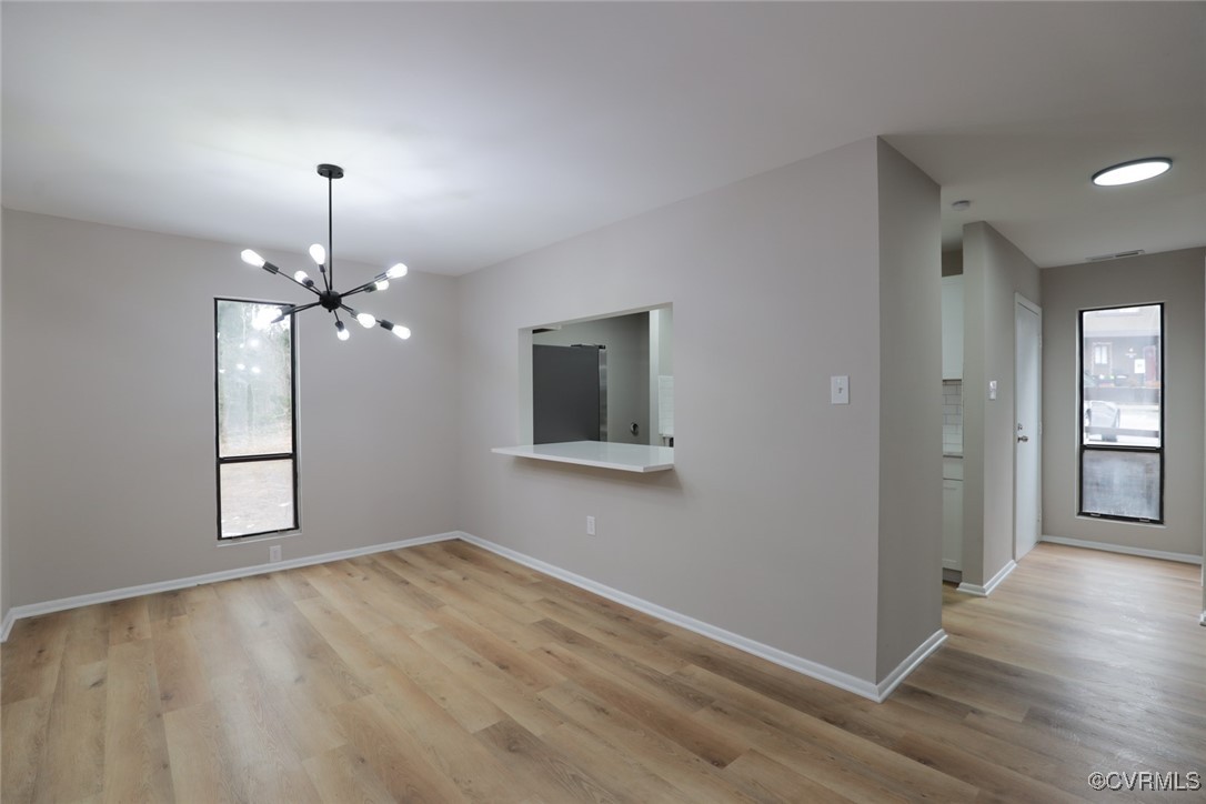 11800 North Briar Patch Drive Midlothian, VA 23113 - Photo 15 of 34 a view of a room with wooden floor chandelier fan and windows