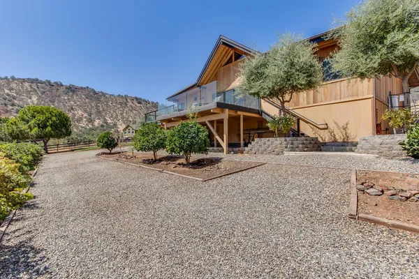 a view of a house with a yard and sitting area