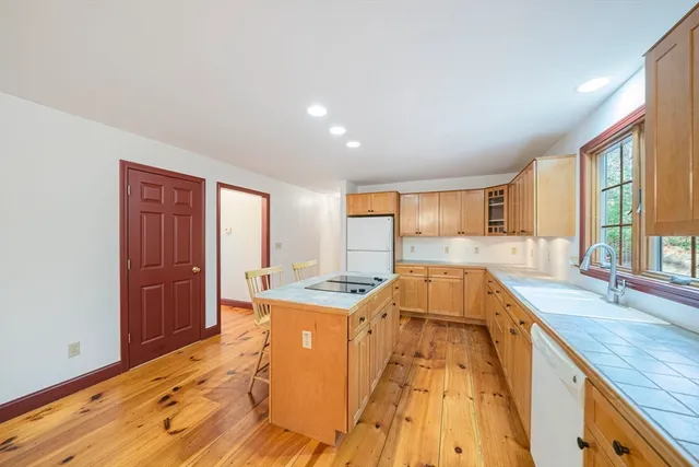 a spacious bathroom with a granite countertop sink and a large mirror