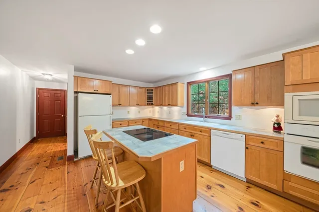 a kitchen that has a sink stainless steel appliances a counter top space and cabinets