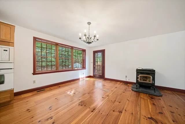 a view of a room with wooden floor and a window