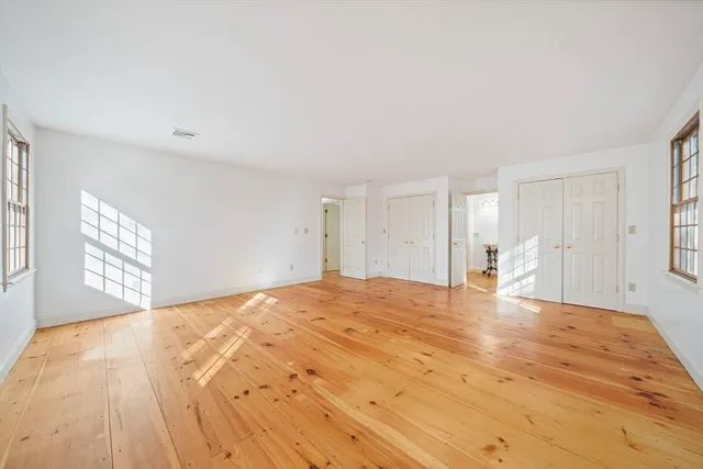 a large bedroom with a bed and a window