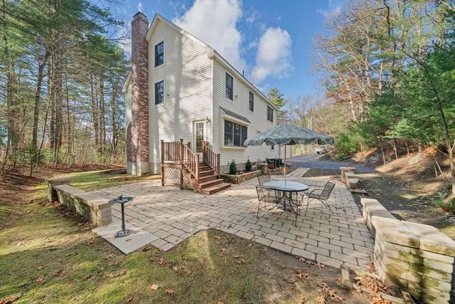 a view of a house with backyard and sitting area