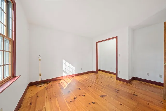 a view of a room with wooden floor