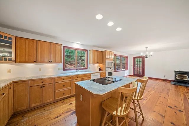 a kitchen with stainless steel appliances granite countertop a sink and a stove