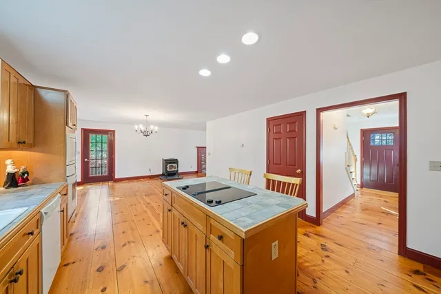 a view of a kitchen that has a sink and a table in it