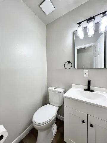 a bathroom with a toilet a sink and mirror