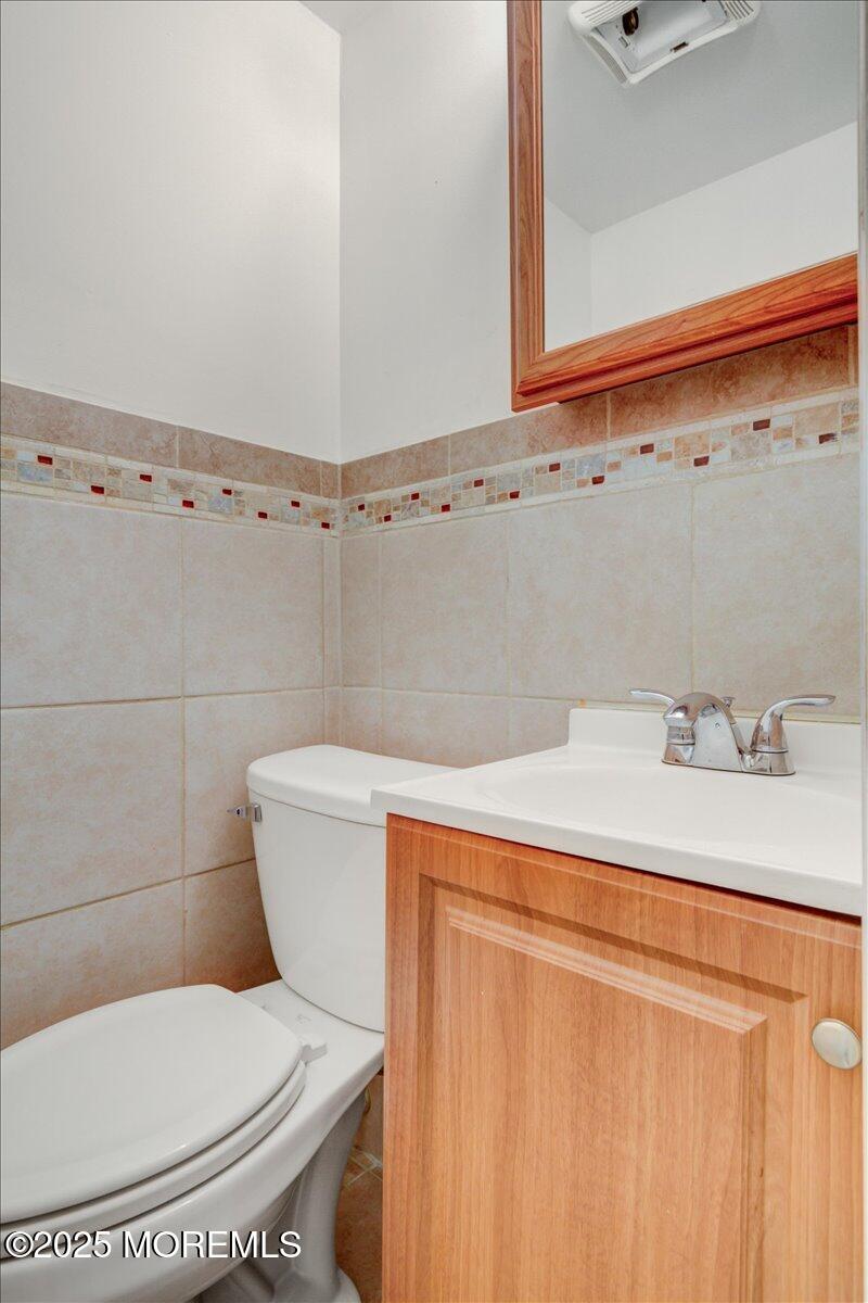 427 Howe Avenue Passaic, NJ 07055 - Photo 13 of 24 a bathroom with a sink a toilet and a mirror