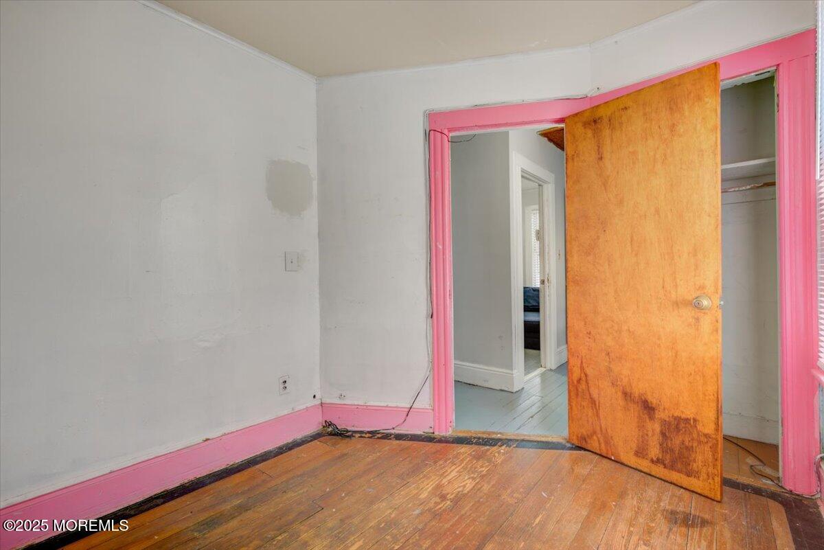 427 Howe Avenue Passaic, NJ 07055 - Photo 20 of 24 a view of an empty room with wooden floor and a window