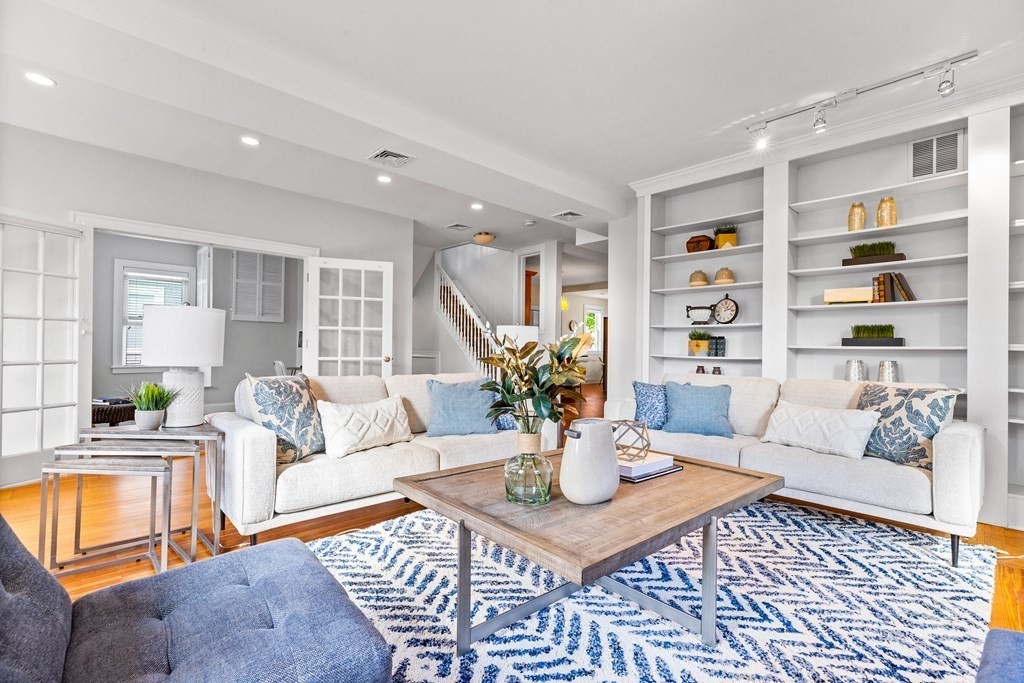 a living room with furniture a rug and a large window