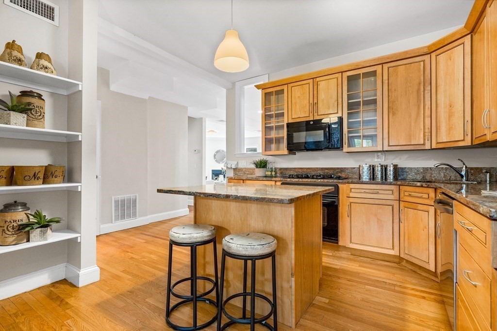 87 Coolidge Street, Unit 2 Brookline, MA 02446 - Photo 2 of 34 a kitchen with stainless steel appliances granite countertop a stove a sink and a refrigerator