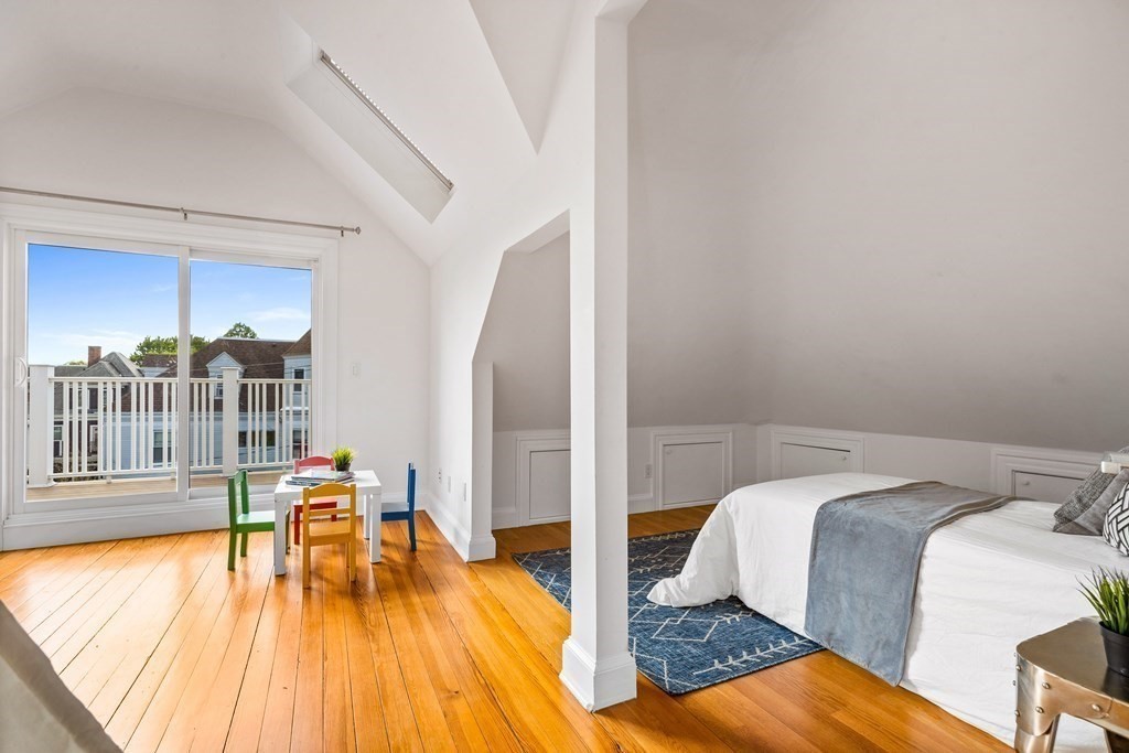 87 Coolidge Street, Unit 2 Brookline, MA 02446 - Photo 22 of 34 a bedroom with a bed and wooden floor