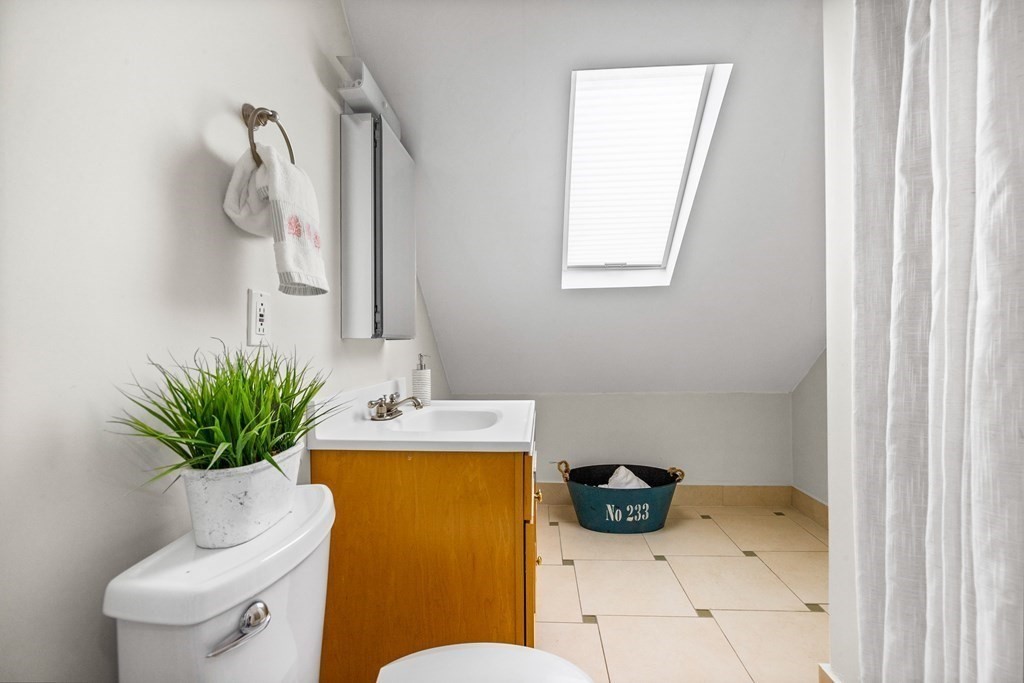 87 Coolidge Street, Unit 2 Brookline, MA 02446 - Photo 25 of 34 a bathroom with a sink a toilet and a mirror
