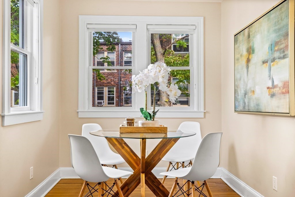 87 Coolidge Street, Unit 2 Brookline, MA 02446 - Photo 3 of 34 a view of a dining room with furniture wooden floor and a window