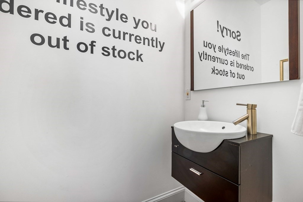 87 Coolidge Street, Unit 2 Brookline, MA 02446 - Photo 10 of 34 a bathroom with a sink and a mirror