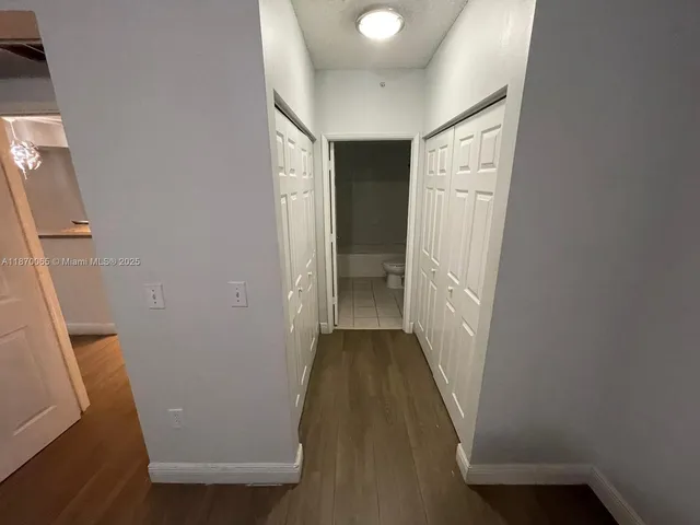 a view of hallway with wooden floor