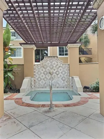 a view of swimming pool with palm trees