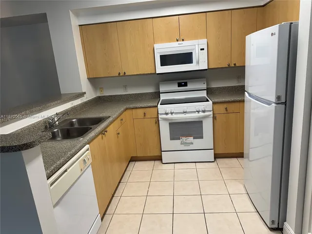 a kitchen with stainless steel appliances a stove a microwave and a refrigerator