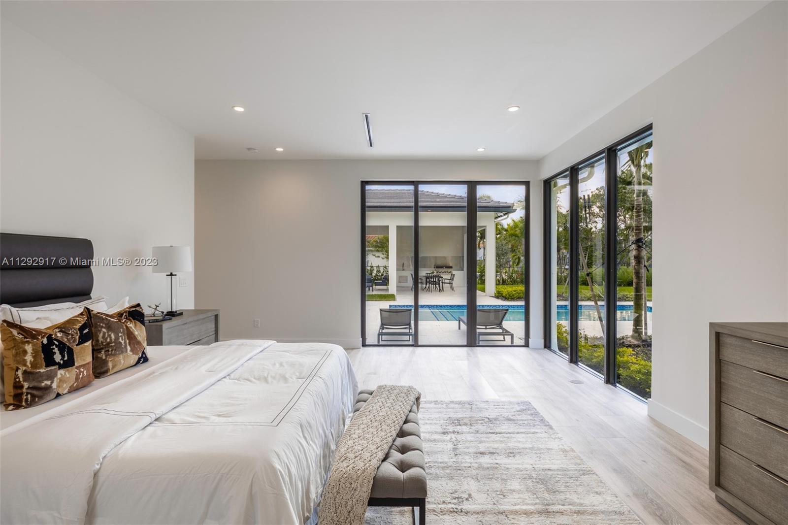 491 Ranch Road Weston, FL 33326 - Photo 23 of 46 a bedroom with a large bed and a large window