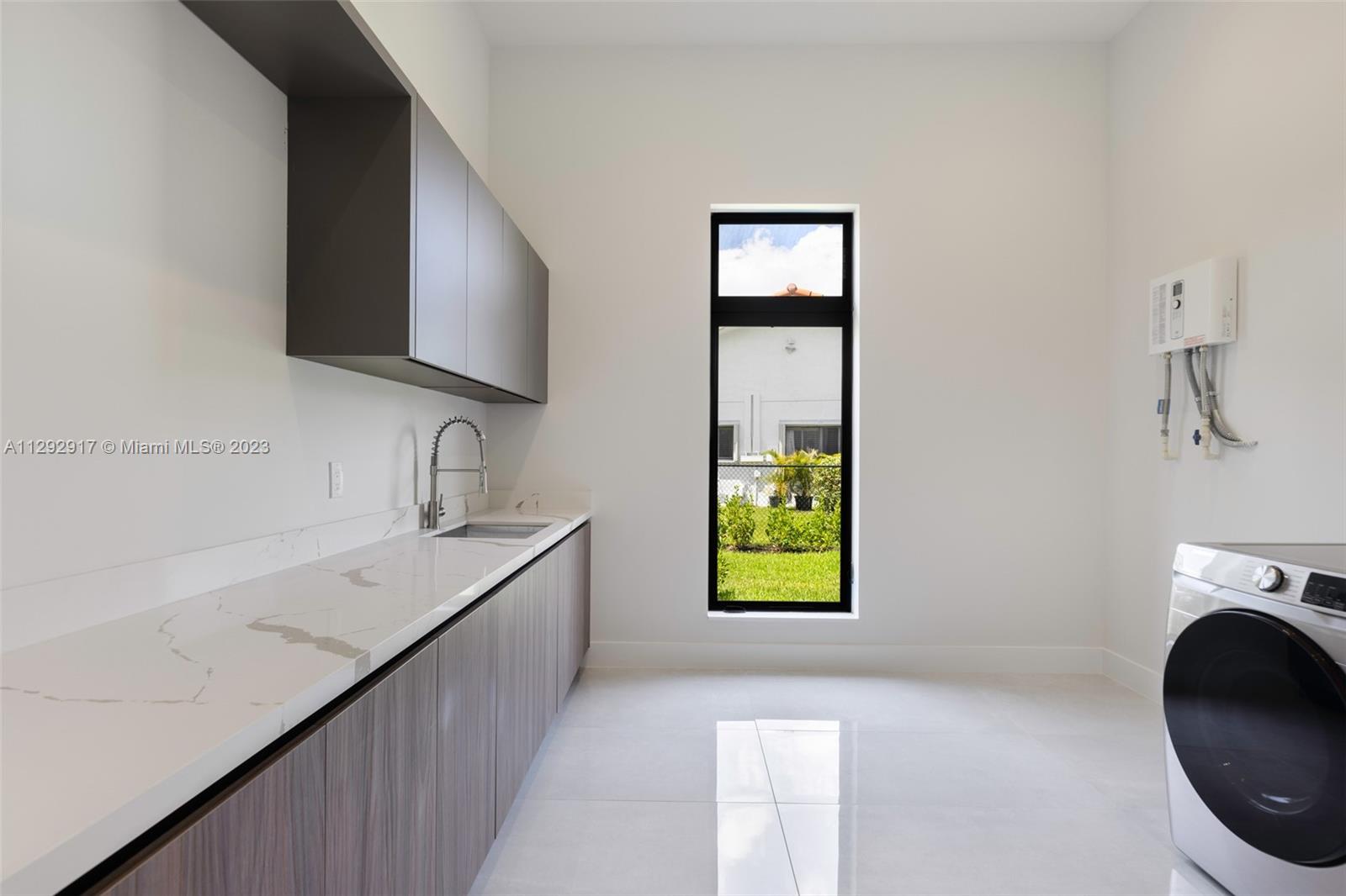 491 Ranch Road Weston, FL 33326 - Photo 35 of 46 a kitchen with a sink stove and cabinets