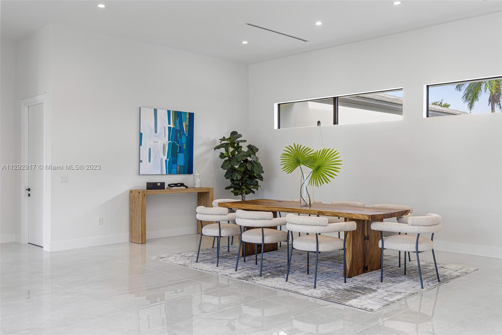 491 Ranch Road Weston, FL 33326 - Photo 7 of 46 a dining room with furniture and a potted plant
