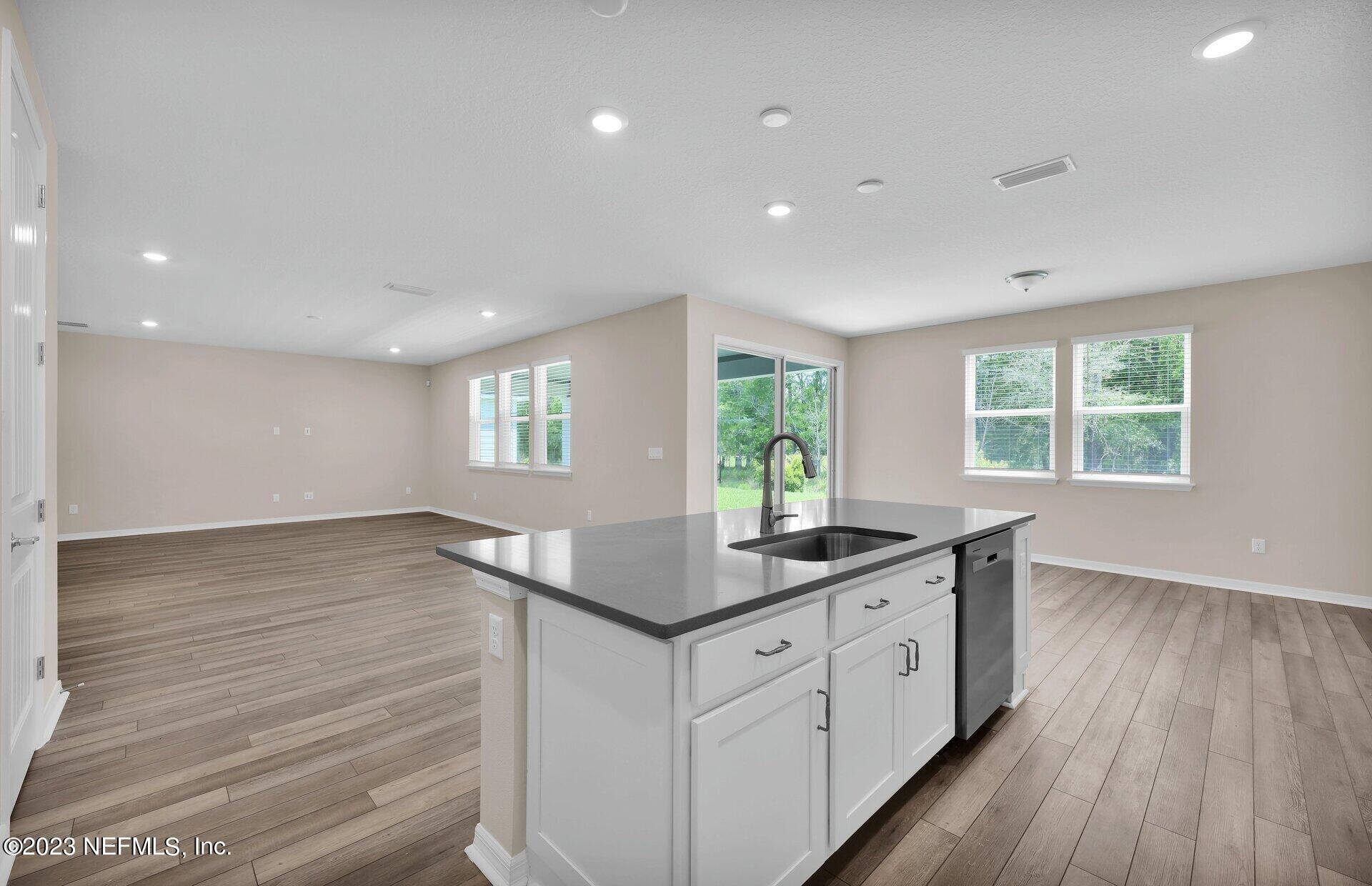 338 Red Barn Road St. Augustine, FL 32092 - Photo 16 of 34 a kitchen with sink cabinets and wooden floor