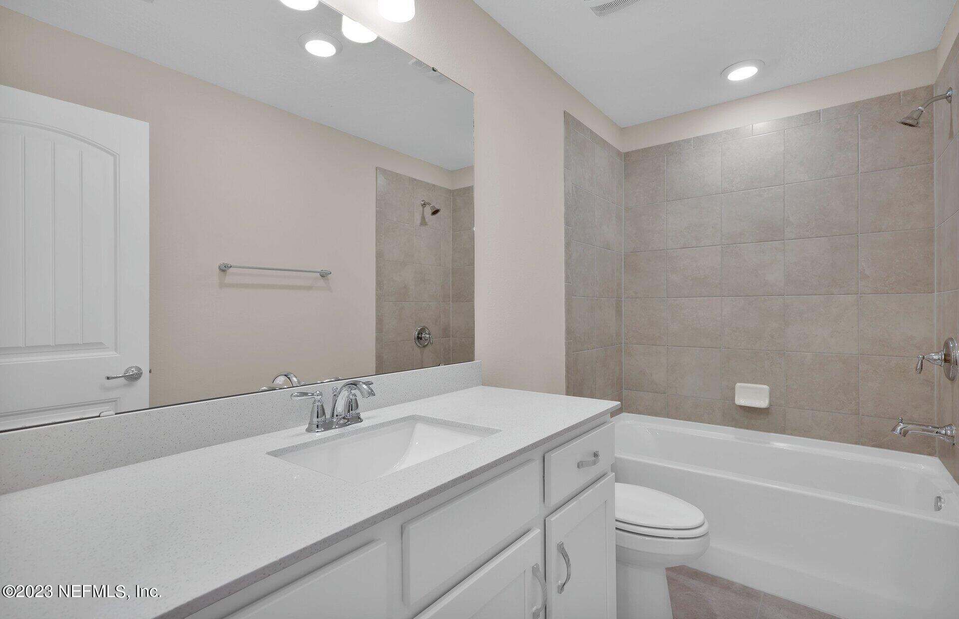 338 Red Barn Road St. Augustine, FL 32092 - Photo 29 of 34 a bathroom with a sink a toilet a tub and a shower