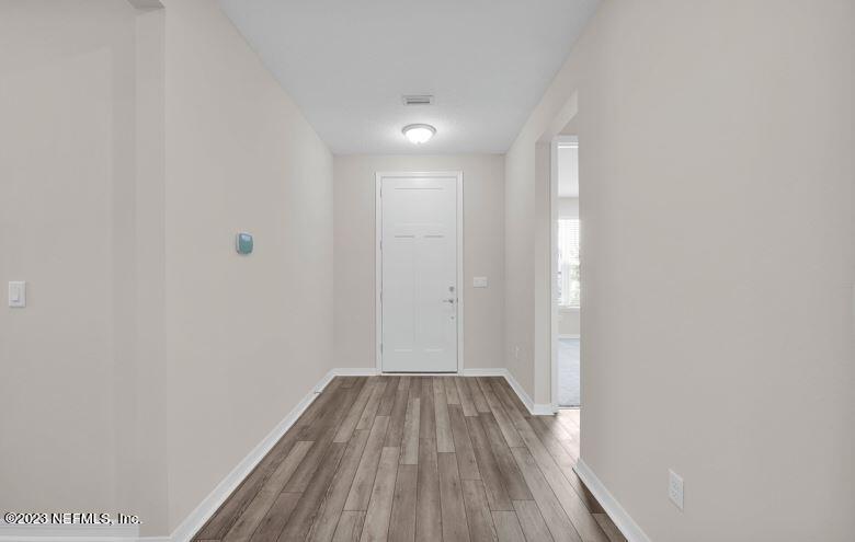 338 Red Barn Road St. Augustine, FL 32092 - Photo 4 of 34 a view of a hallway with wooden floor