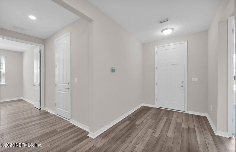 338 Red Barn Road St. Augustine, FL 32092 - Photo 5 of 34 a view of a hallway with wooden floor