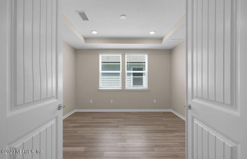 338 Red Barn Road St. Augustine, FL 32092 - Photo 7 of 34 a view of empty room with wooden floor and fan