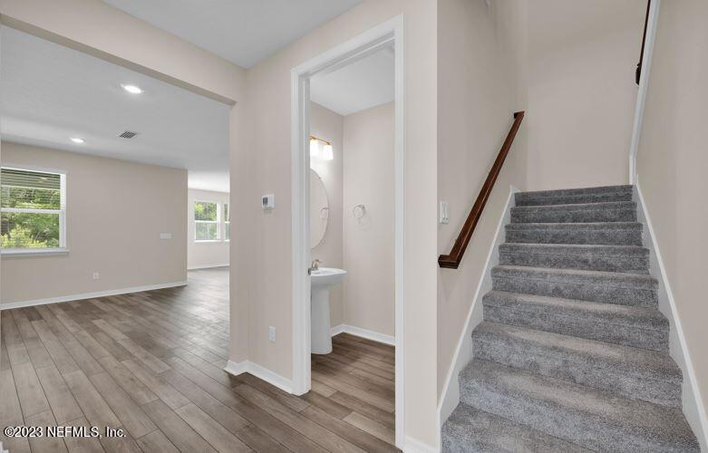 338 Red Barn Road St. Augustine, FL 32092 - Photo 8 of 34 a view of an entryway with wooden floor and staircase