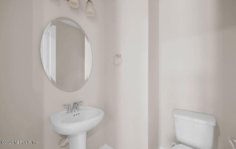 338 Red Barn Road St. Augustine, FL 32092 - Photo 9 of 34 a bathroom with a sink a mirror and toilet