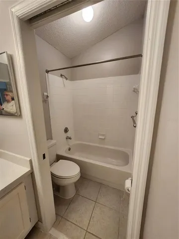 a bathroom with a granite countertop toilet a sink and a shower