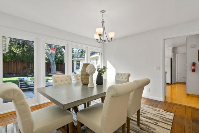 a view of a dining room with furniture wooden floor and chandelier